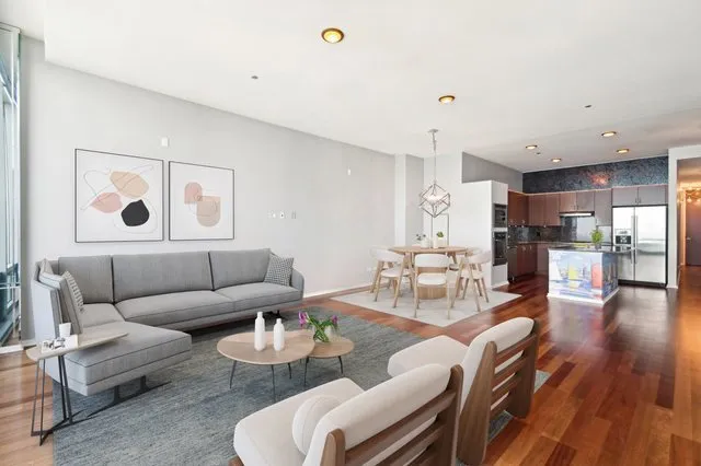 a living room with furniture and kitchen view
