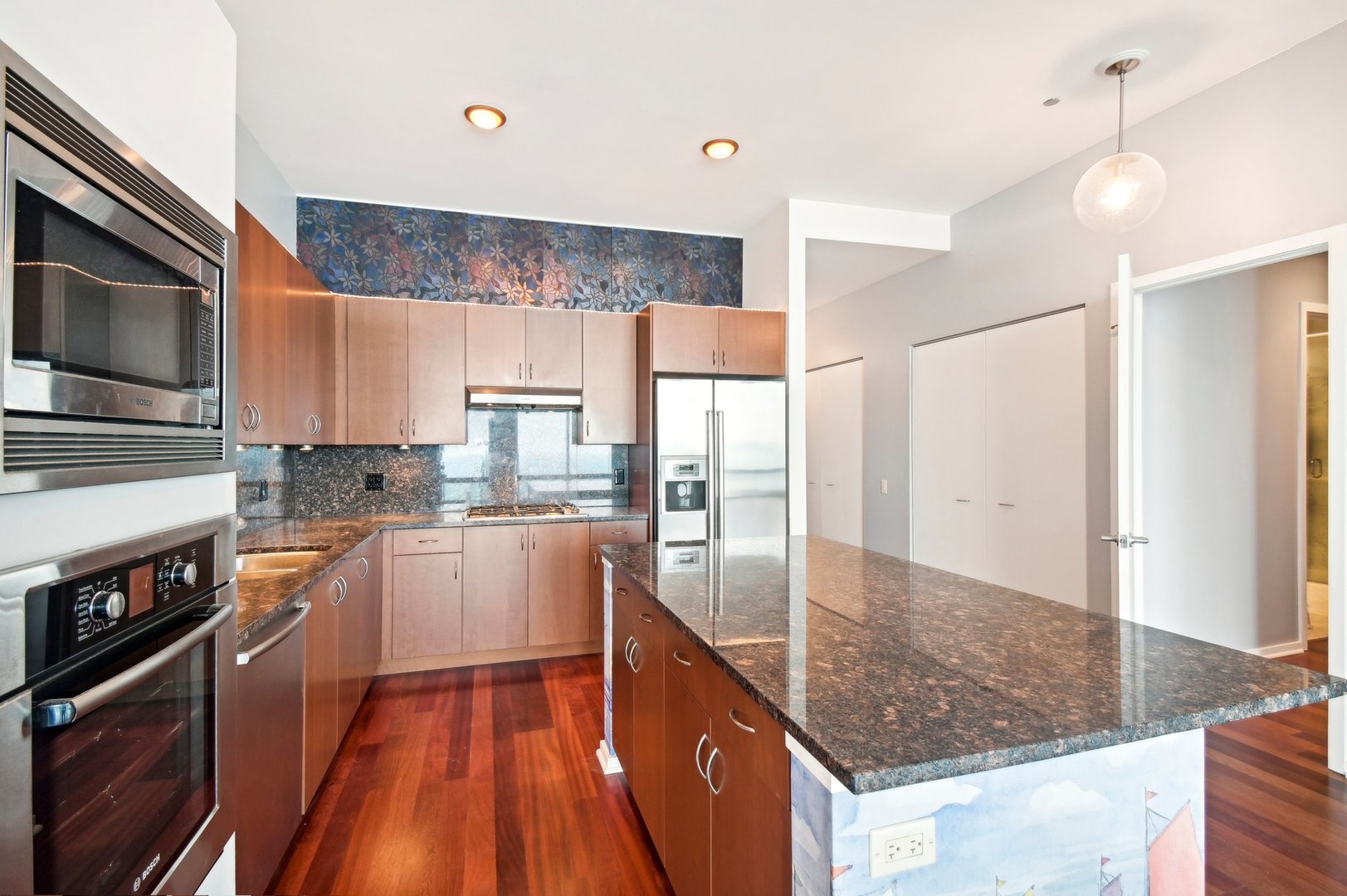 65 East Monroe Street, Unit 4521 Chicago, IL 60603 - Photo 9 of 42 a kitchen with stainless steel appliances granite countertop a stove a sink and a refrigerator