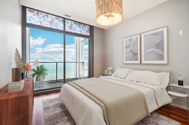 a bedroom with a large bed and a large window