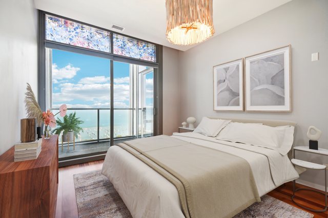 65 East Monroe Street, Unit 4521 Chicago, IL 60603 - Photo 10 of 42 a bedroom with a large bed and a large window
