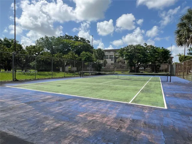a kitchen with kitchen island granite countertop a sink and a stove