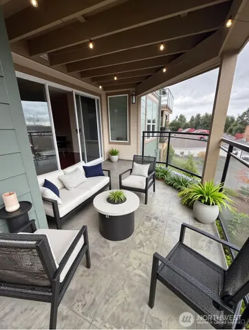 a living room with patio furniture and a potted plant
