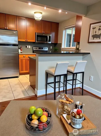 a kitchen with stainless steel appliances wooden cabinets and a counter top space