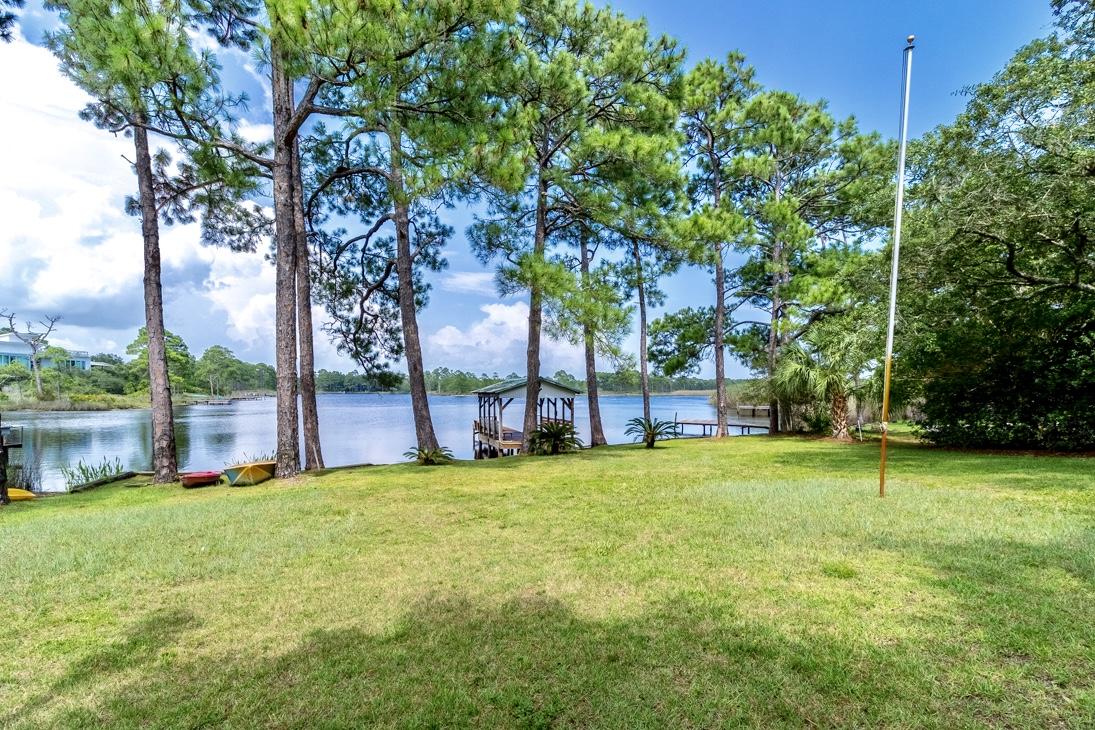 79 Garfield Street Santa Rosa Beach, FL 32459 - Photo 6 of 49 a view of a house with a big yard and large trees