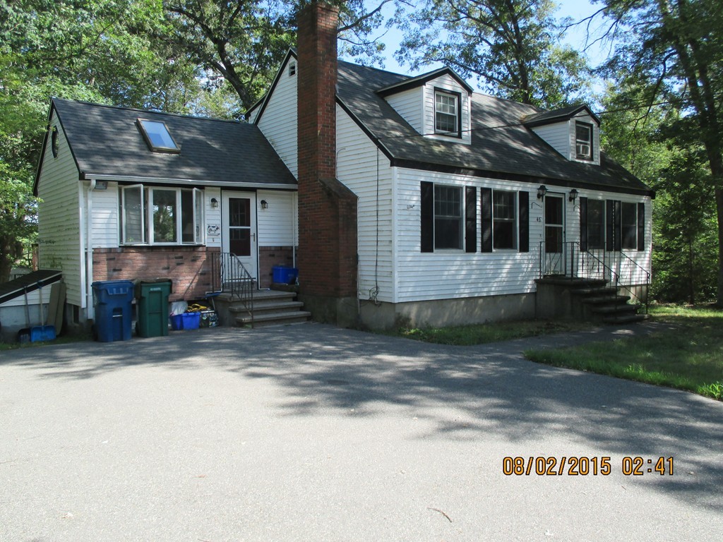 a view of house with a yard