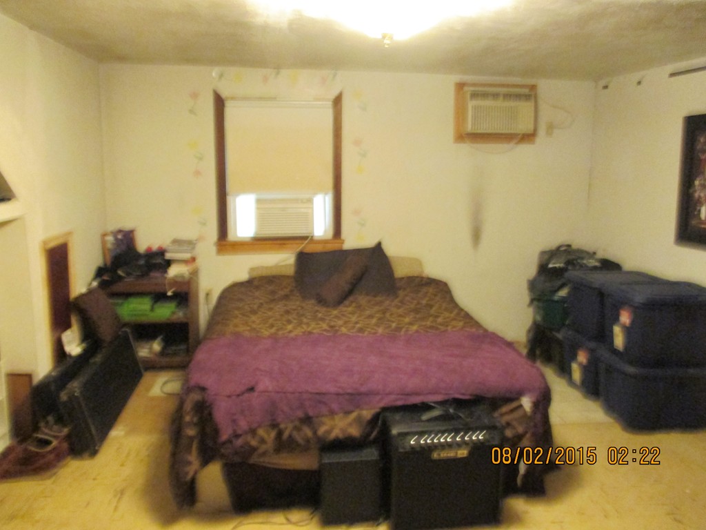 48 Shawsheen Road Billerica, MA 01821 - Photo 13 of 18 a bedroom with a bed and wooden floor