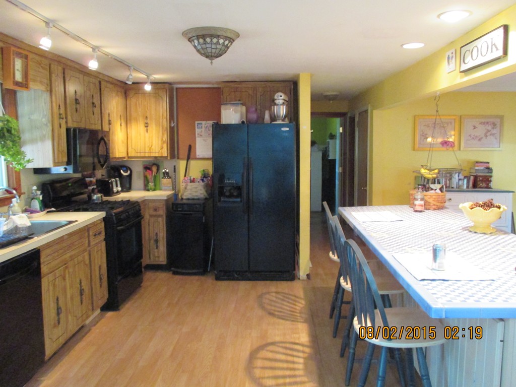 48 Shawsheen Road Billerica, MA 01821 - Photo 6 of 18 a kitchen with refrigerator and cabinets