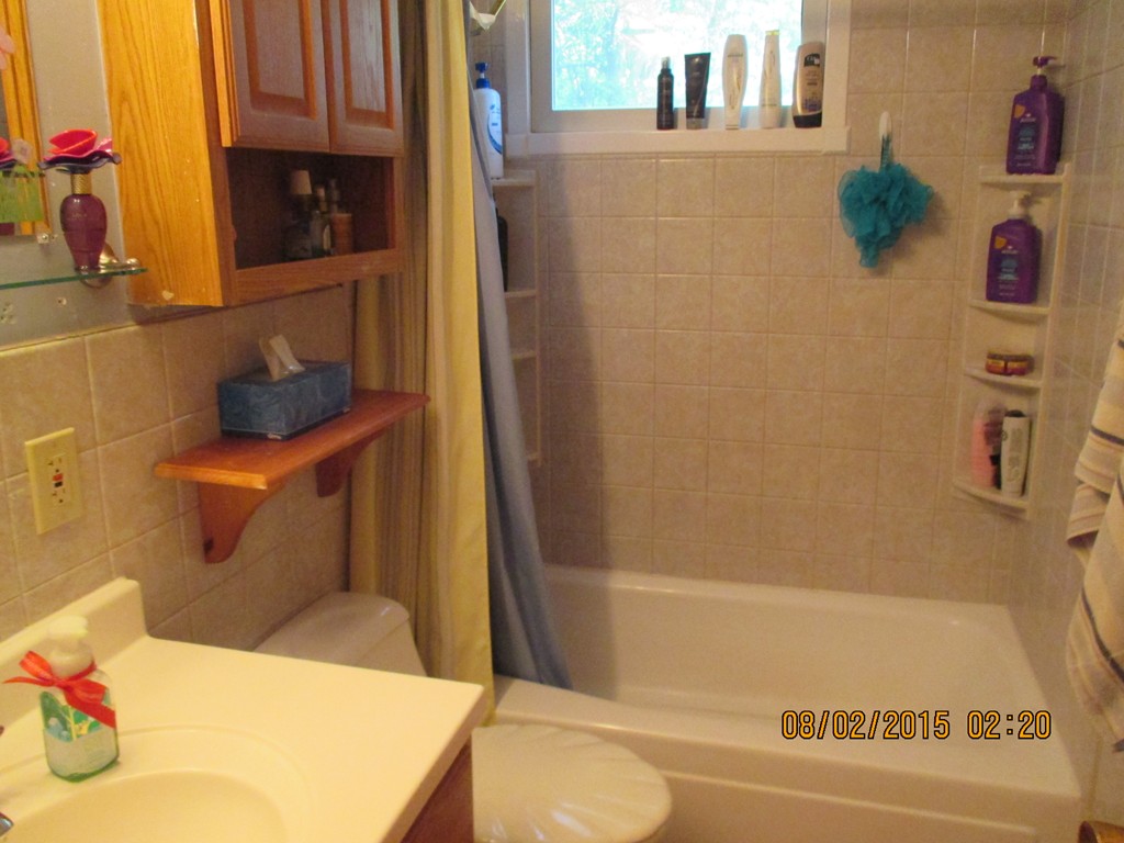 48 Shawsheen Road Billerica, MA 01821 - Photo 9 of 18 a bathroom with a bathtub sink and toilet