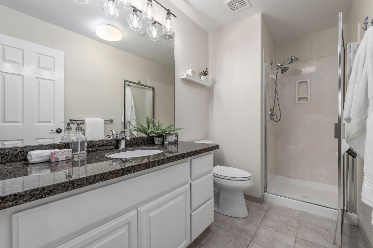 10 Towne Circle Mountain View, CA 94040 - Photo 21 of 28 a bathroom with a granite countertop sink a toilet and a mirror