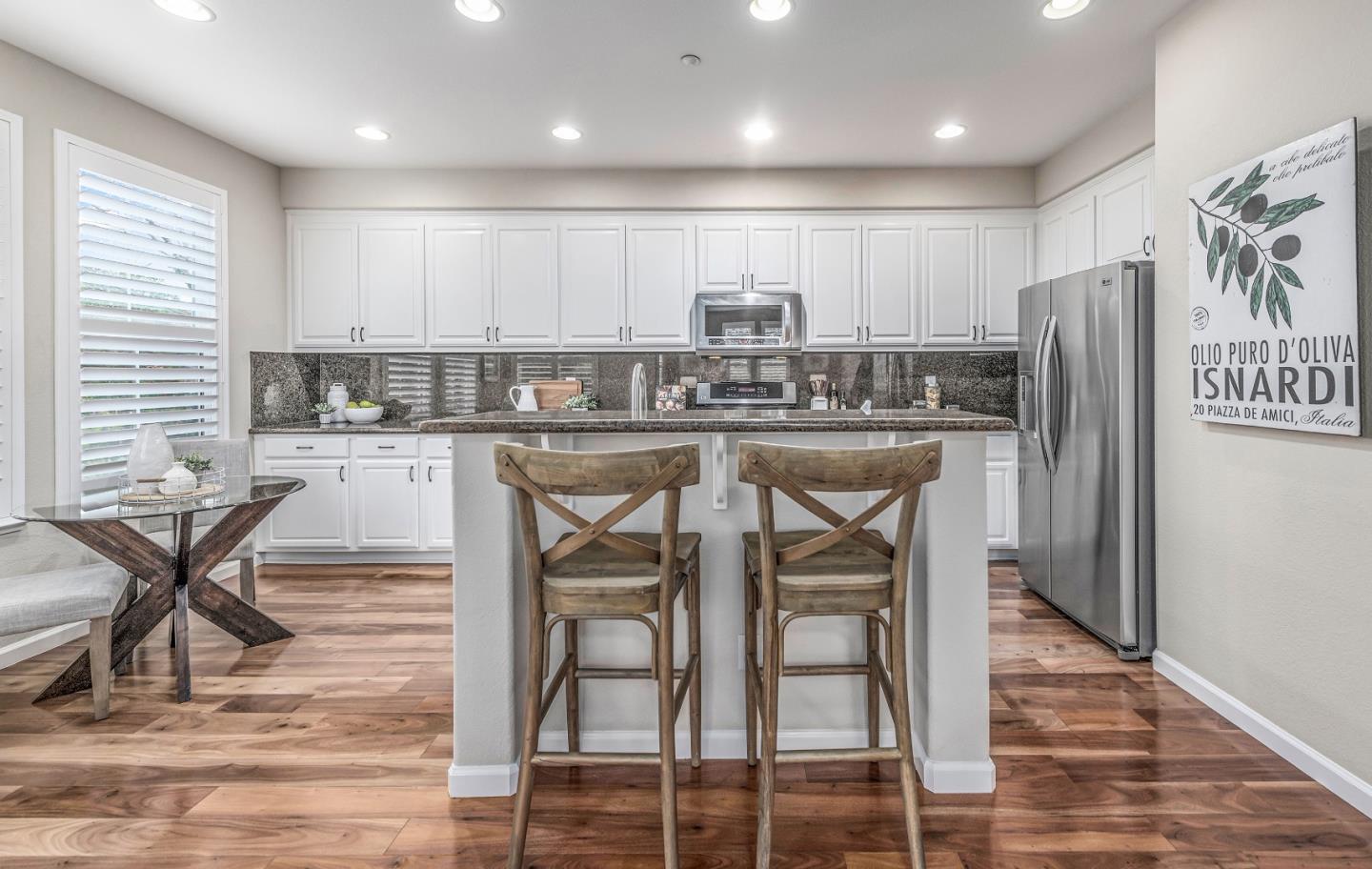 10 Towne Circle Mountain View, CA 94040 - Photo 5 of 28 a kitchen with stainless steel appliances granite countertop a table chairs stove and refrigerator