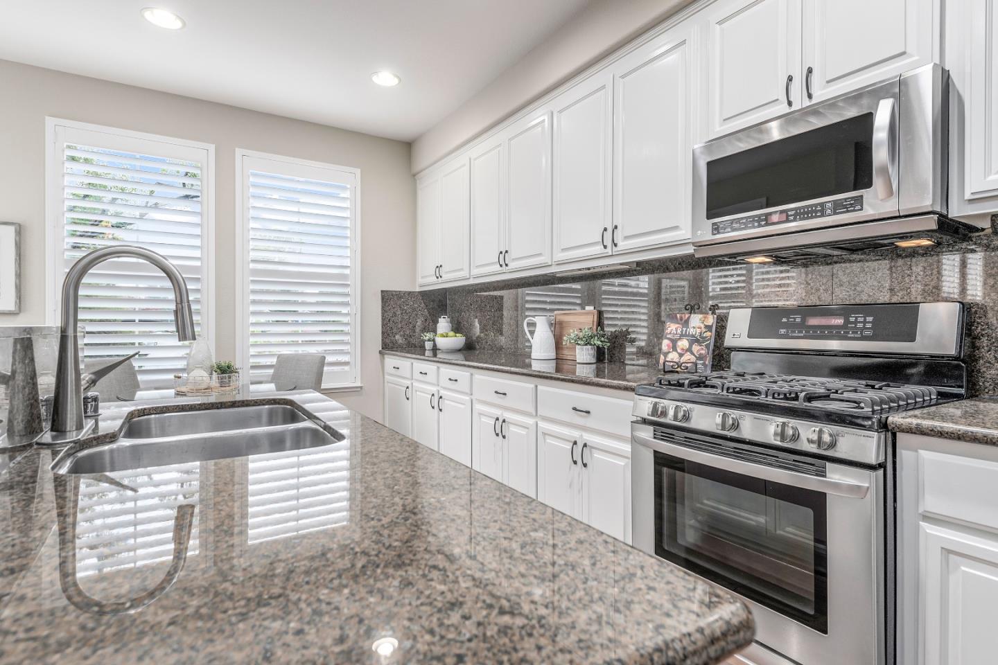 10 Towne Circle Mountain View, CA 94040 - Photo 7 of 28 a kitchen with granite countertop a stove a sink and a microwave