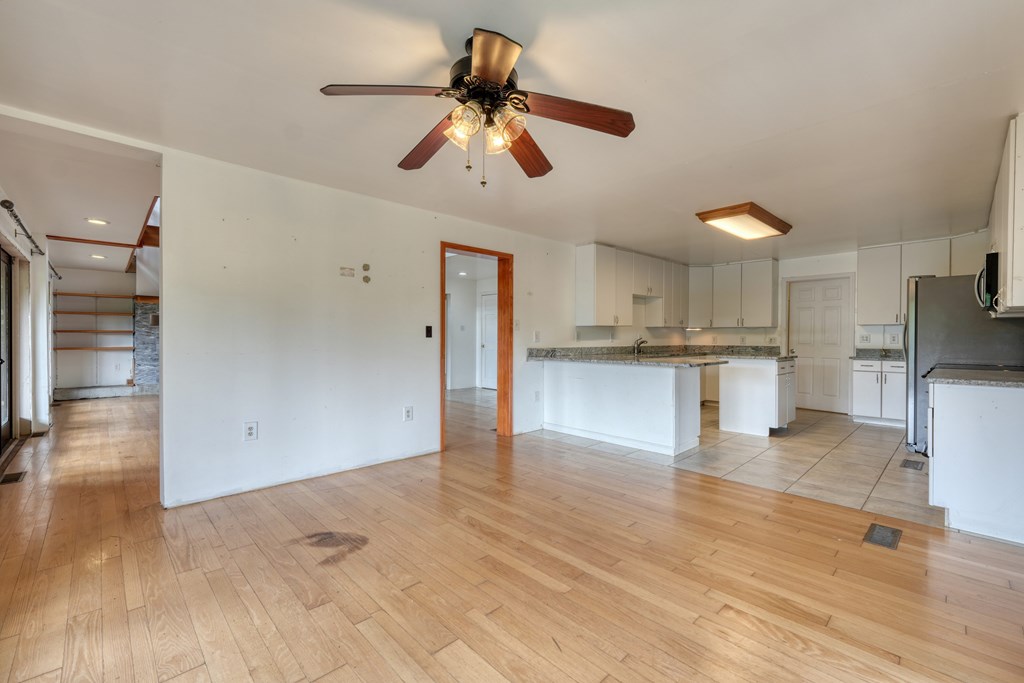 89 Simmons Ridge Mineral Bluff, GA 30559 - Photo 19 of 82 a view of kitchen with wooden floor and window