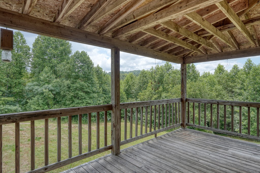 89 Simmons Ridge Mineral Bluff, GA 30559 - Photo 23 of 82 a view of a wooden deck next to a yard