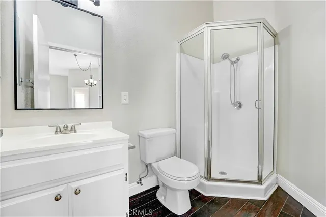 a bathroom with a toilet a sink and a mirror