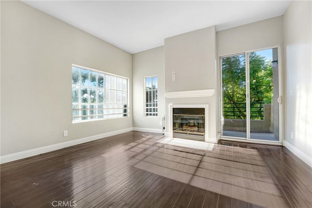 6140 Monterey Road, Unit 406 Los Angeles, CA 90042 - Photo 3 of 26 a view of an empty room with wooden floor fireplace and a window