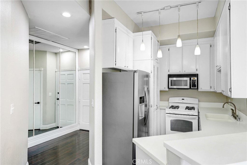6140 Monterey Road, Unit 406 Los Angeles, CA 90042 - Photo 5 of 26 a kitchen with stainless steel appliances a refrigerator sink and microwave