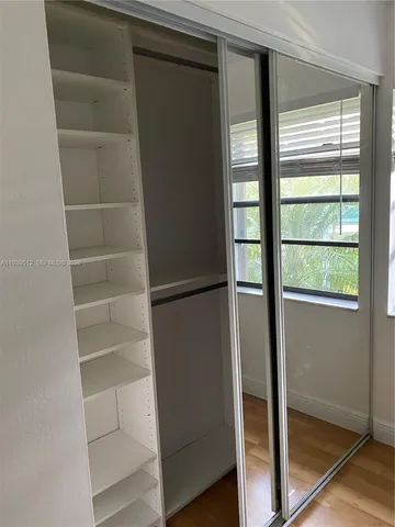 a view of walk in closet with empty racks