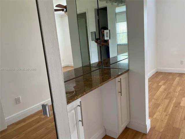 a view of hallway with wooden floor