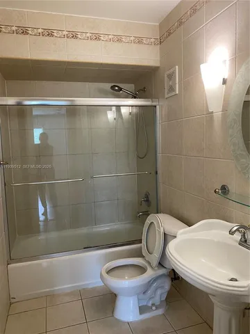 a bathroom with a sink a toilet and bathtub