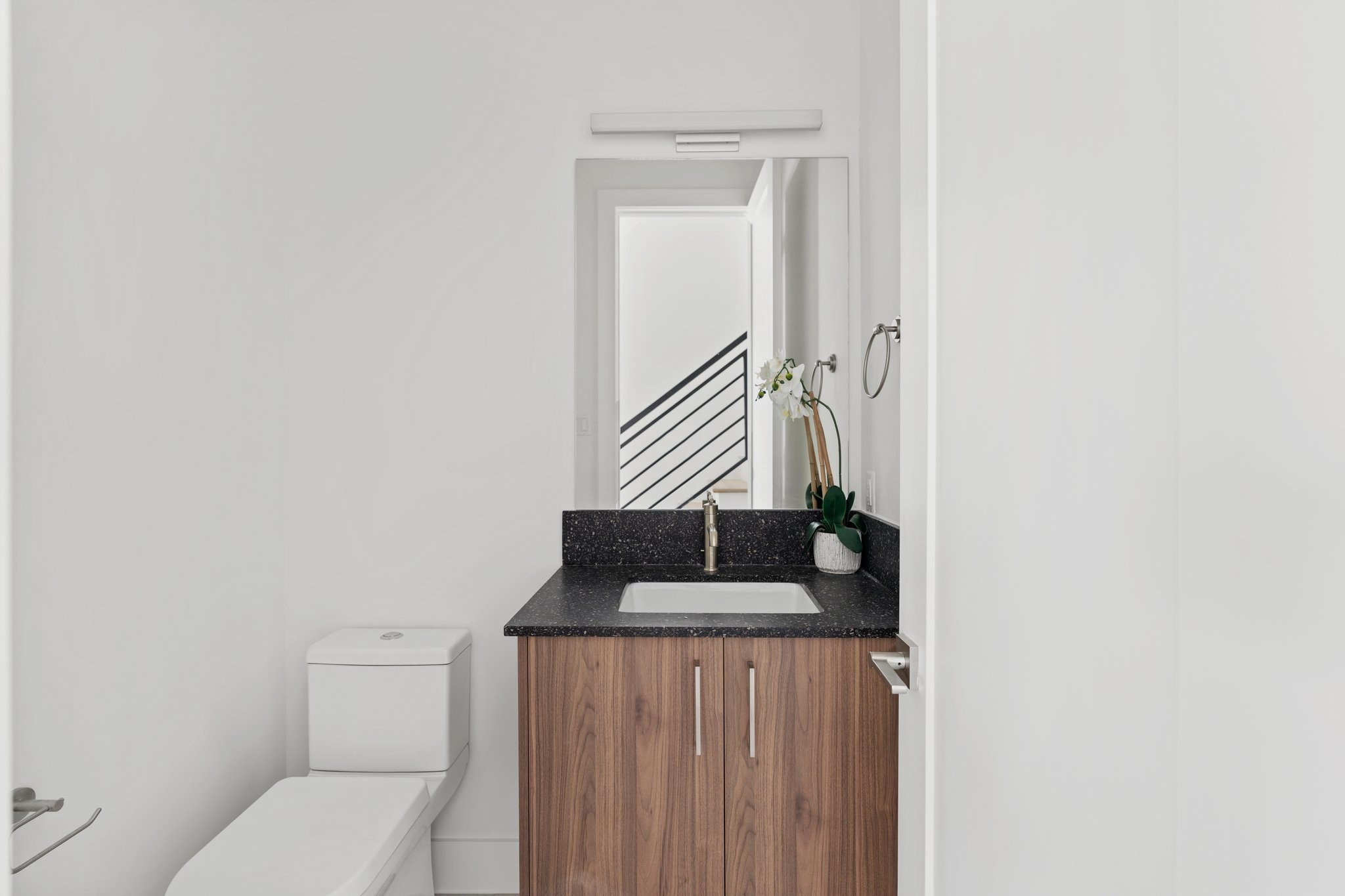 111 East 32nd Street, Unit C Houston, TX 77018 - Photo 13 of 31 Elegant powder room featuring quartz countertops, custom cabinetry by GoBravura, and refined finishes.