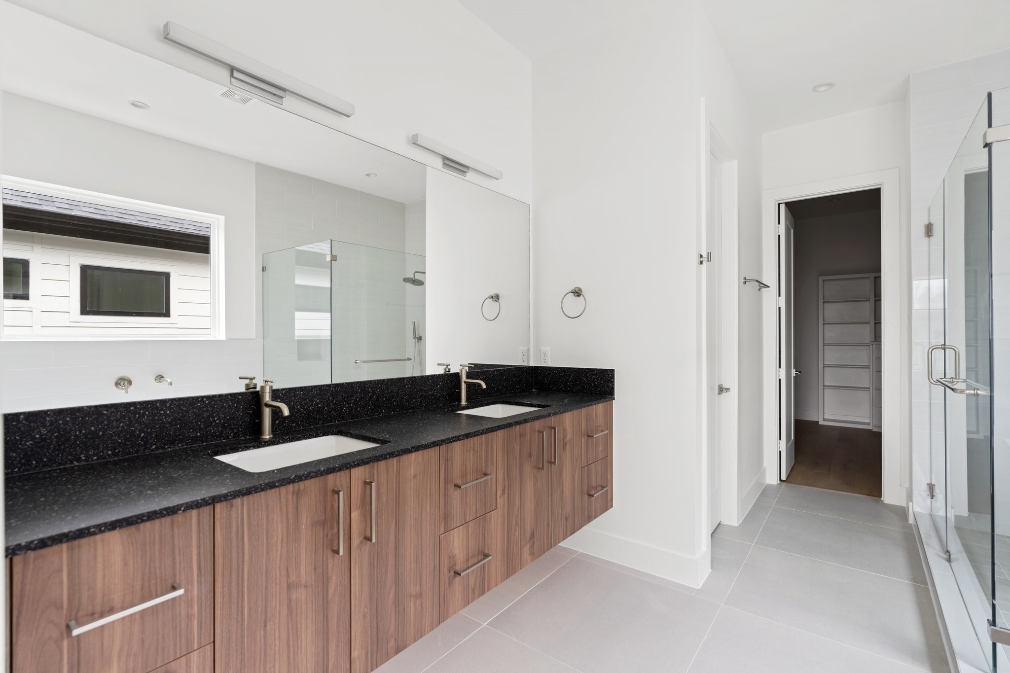 111 East 32nd Street, Unit C Houston, TX 77018 - Photo 18 of 31 His-and-hers vanity areas with quartz countertops, high-end Moen plumbing fixtures, and cabinetry by GoBravura.