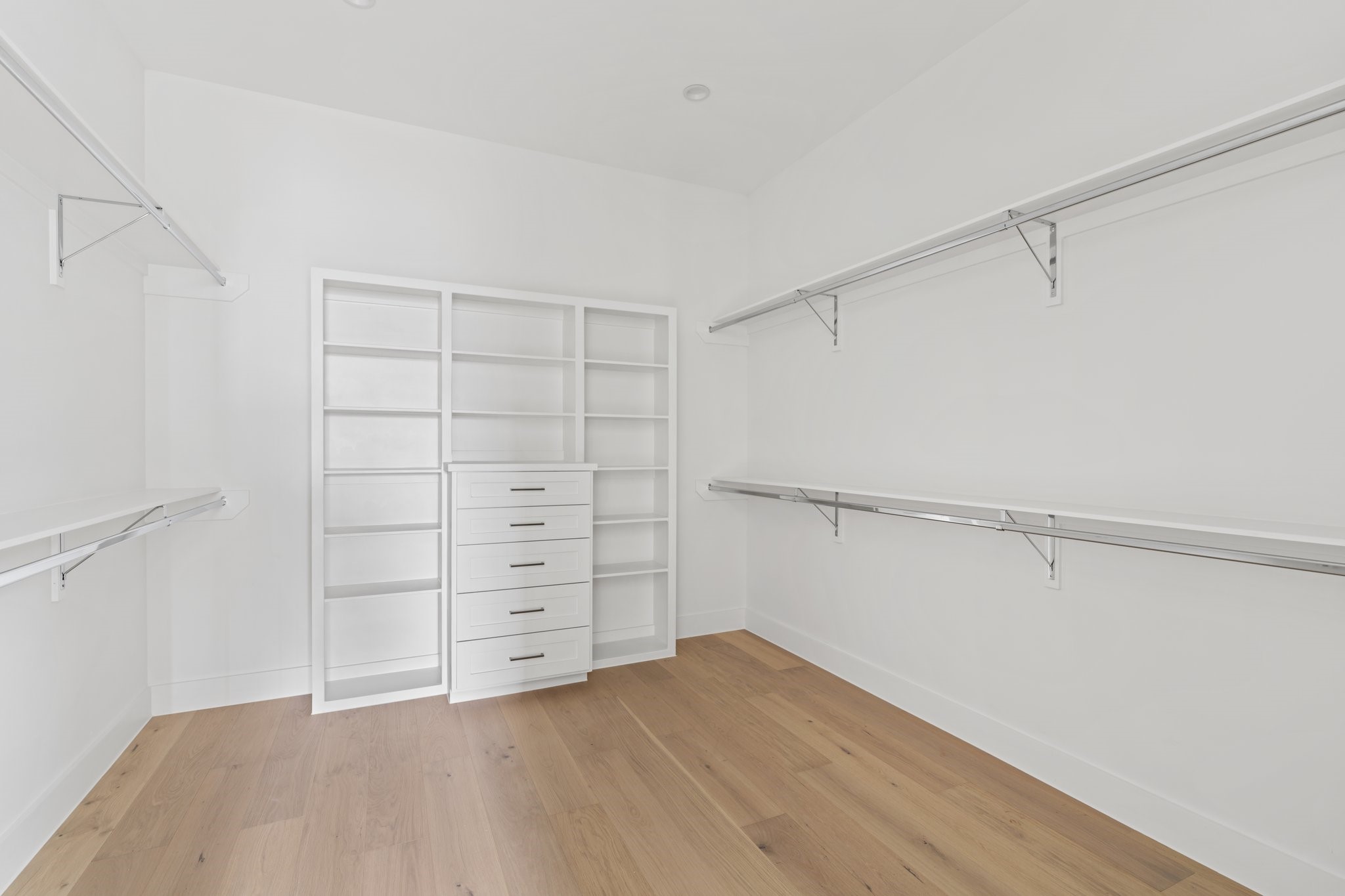 111 East 32nd Street, Unit C Houston, TX 77018 - Photo 20 of 31 Expansive primary closet with built-in storage solutions, offering ample space and organization.