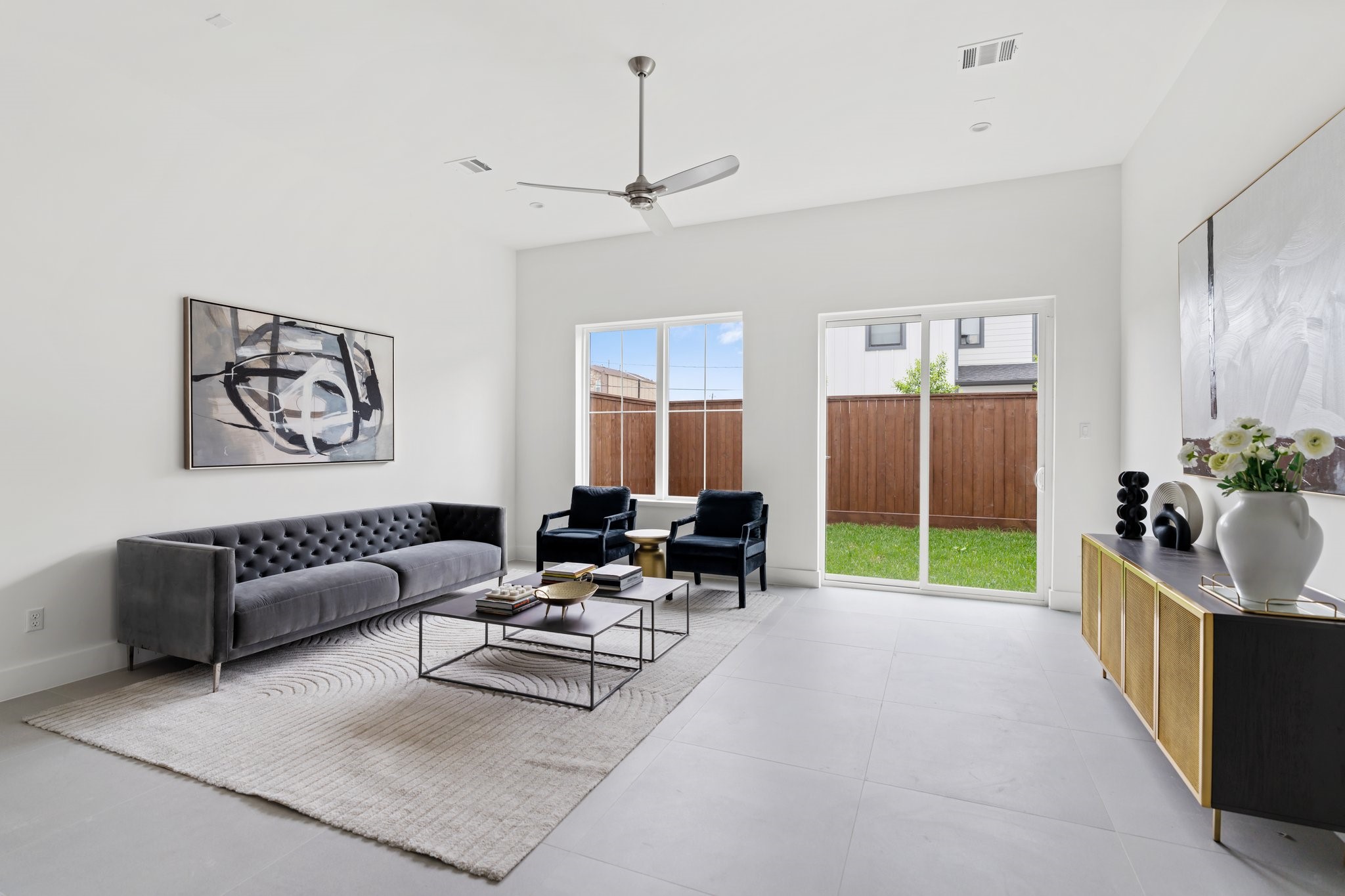 111 East 32nd Street, Unit C Houston, TX 77018 - Photo 2 of 31 Spacious and inviting, the family room features soaring 11’ ceilings and seamless access to the backyard through sliding doors.