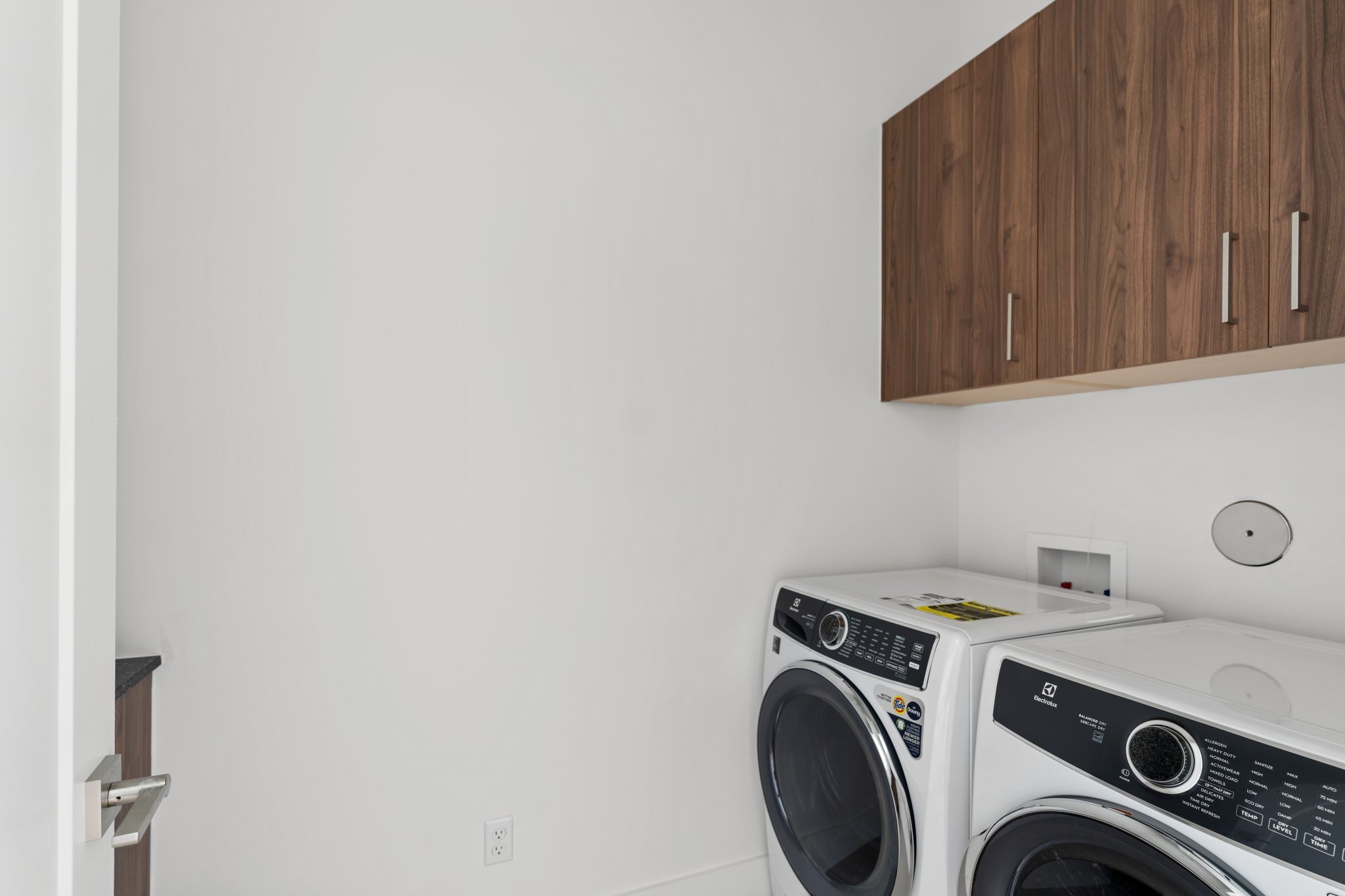 111 East 32nd Street, Unit C Houston, TX 77018 - Photo 21 of 31 Convenient second-floor laundry with an Electrolux front-load washer and dryer, plus built-in counter space for folding.