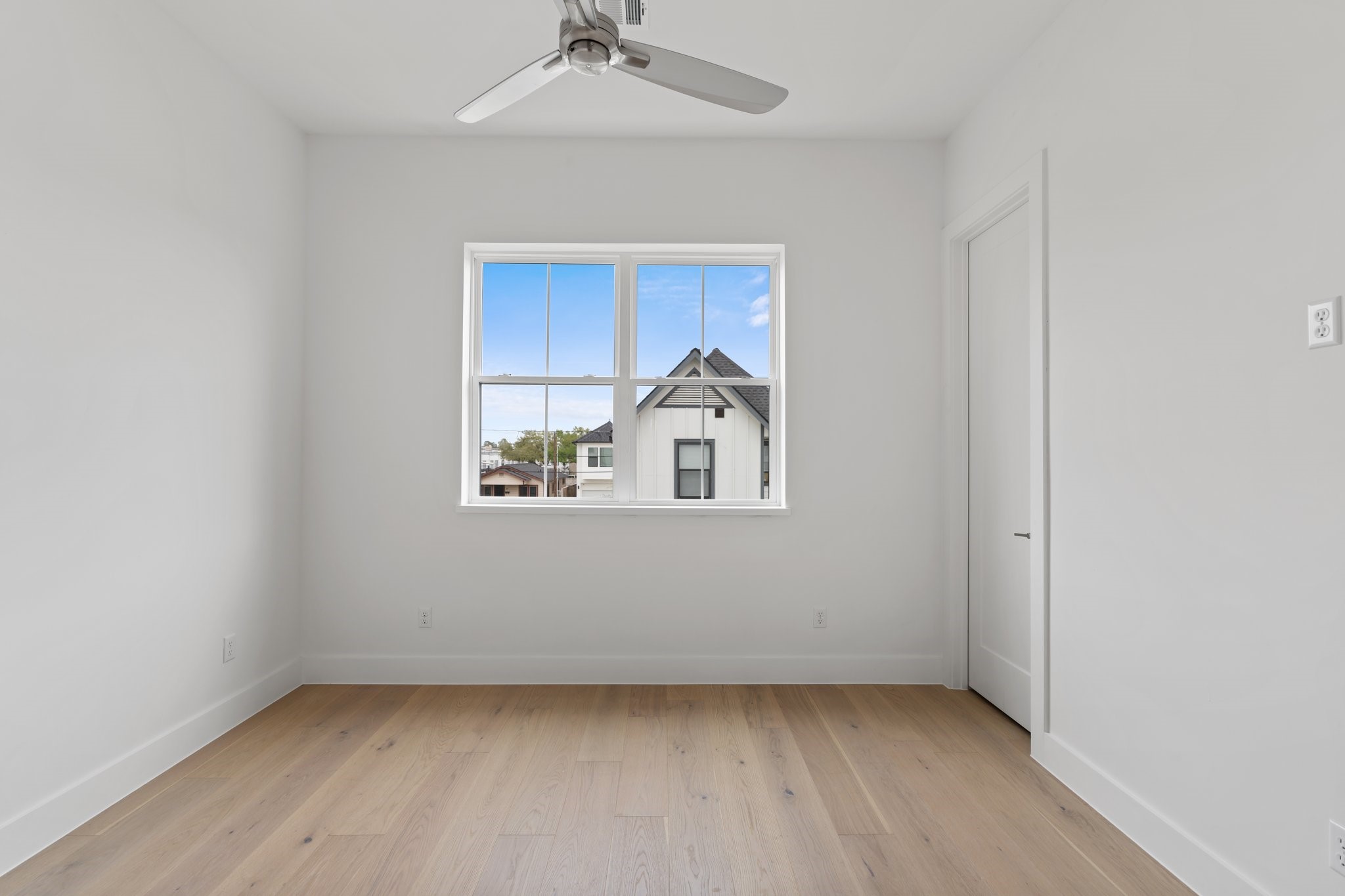 111 East 32nd Street, Unit C Houston, TX 77018 - Photo 22 of 31 Bright and spacious with large windows, a private walk-in closet, and a MinkaAire ceiling fan.
