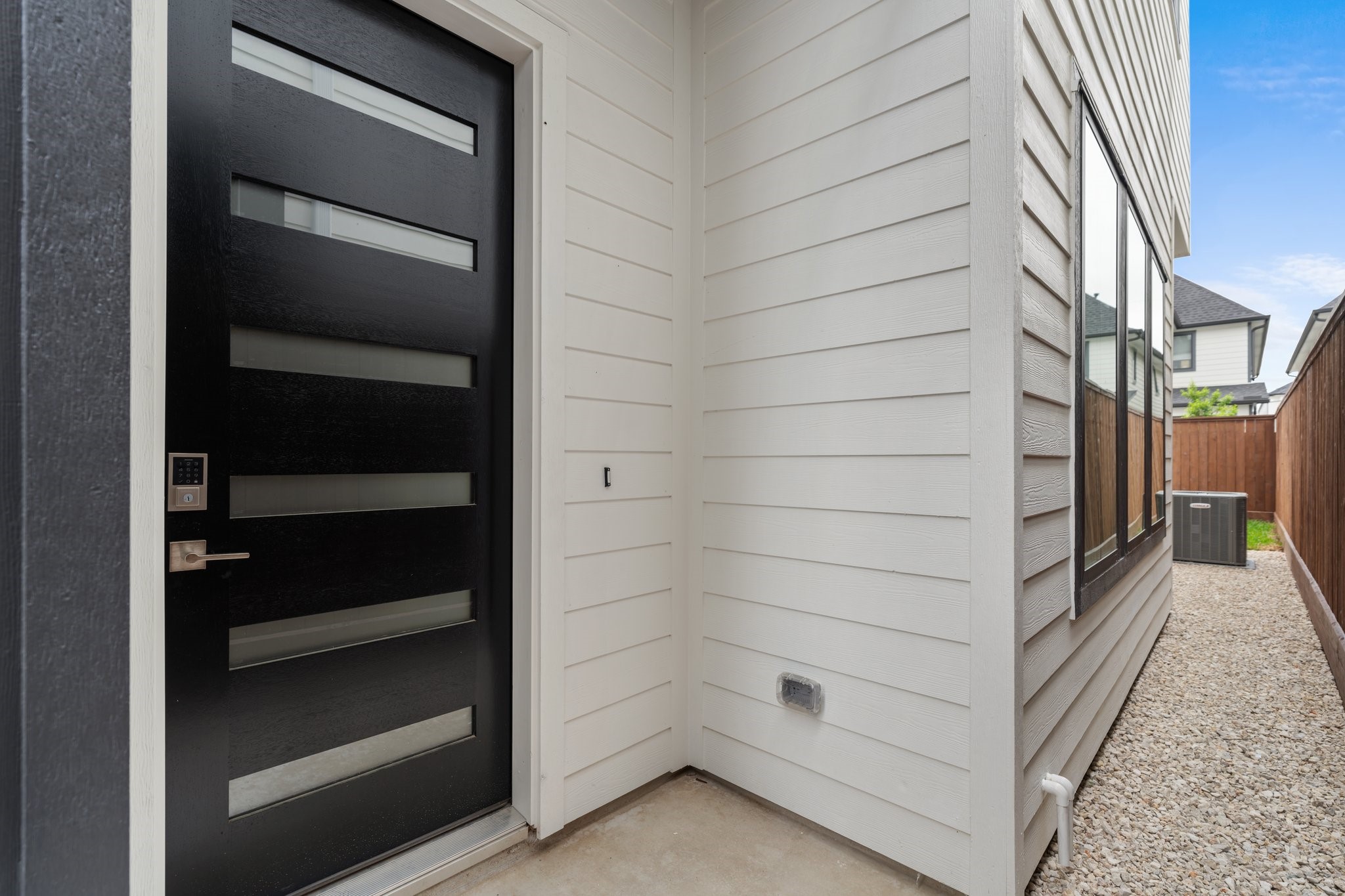111 East 32nd Street, Unit C Houston, TX 77018 - Photo 27 of 31 Secure and stylish entry with a designer wood and frosted glass front door, plus a 7’ steel security gate with a digital locking system.