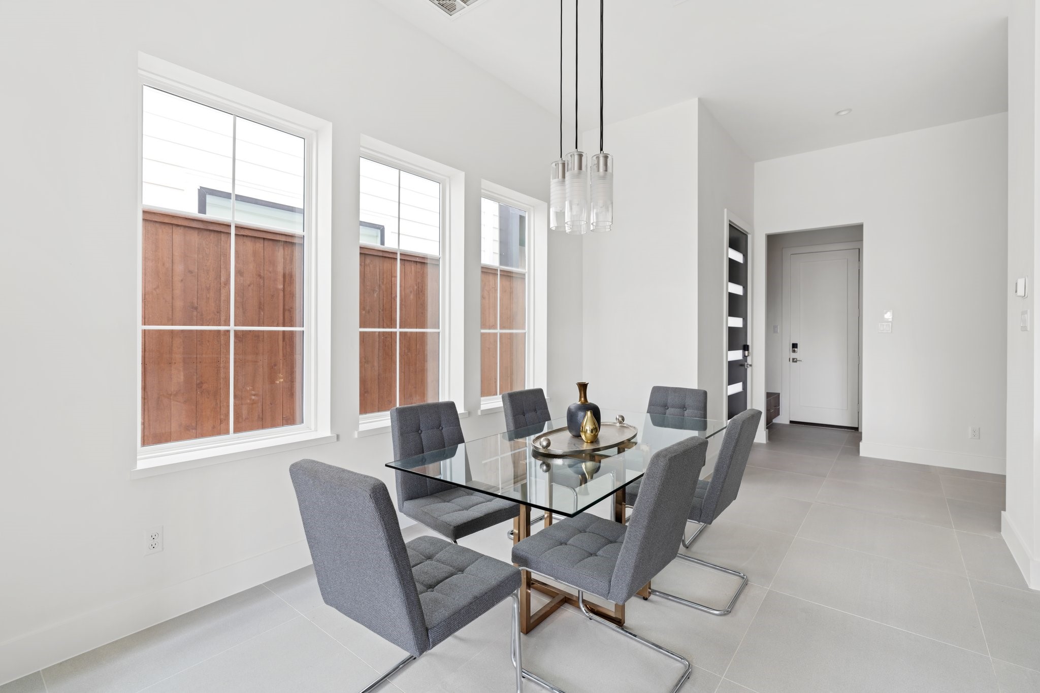 111 East 32nd Street, Unit C Houston, TX 77018 - Photo 7 of 31 Sophisticated dining area bathed in natural light from oversized windows, creating the perfect ambiance for entertaining