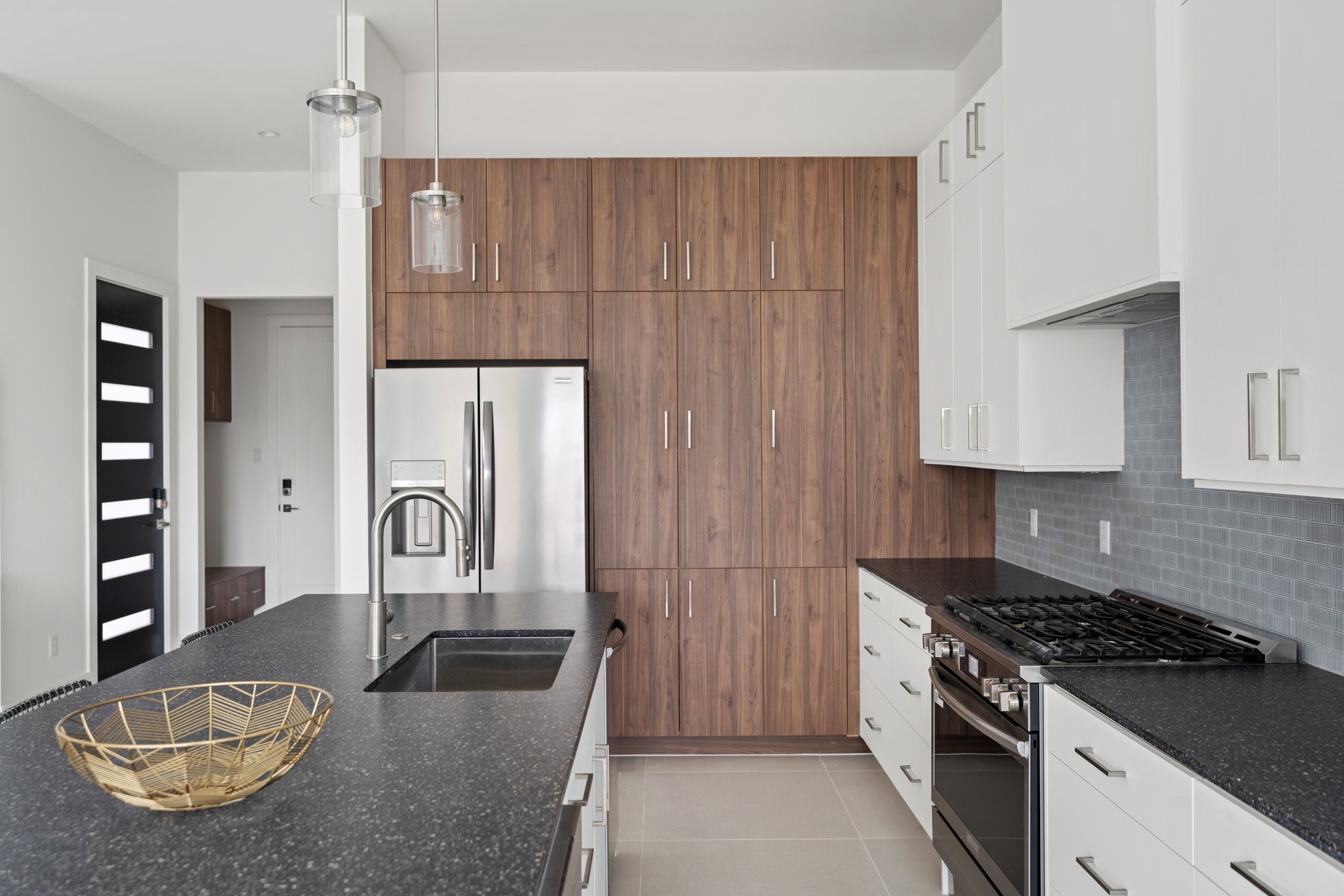 111 East 32nd Street, Unit C Houston, TX 77018 - Photo 9 of 31 Gourmet chef's kitchen epitomizes functional luxury with a custom appliance garage, generous storage solutions, and sophisticated design elements. The adjacent walk-in pantry enhances convenience and organization.