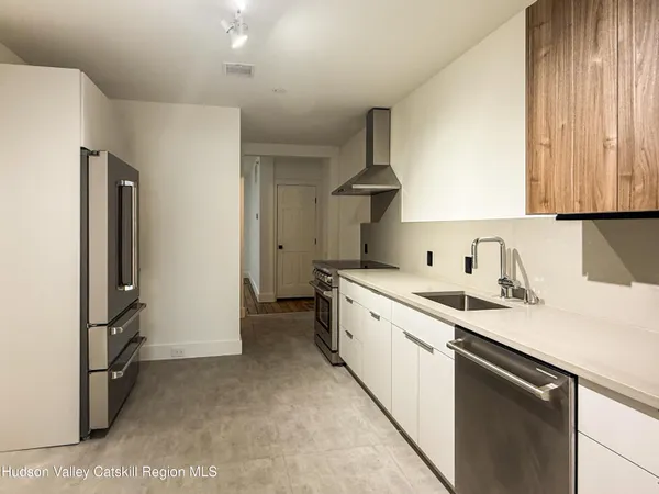 a kitchen with a sink appliances and cabinets