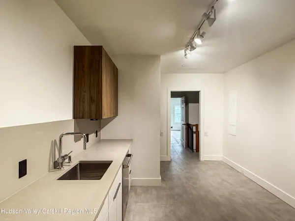 a kitchen with a sink and a refrigerator