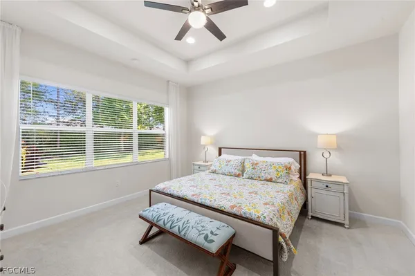 a bedroom with a bed mirror and window