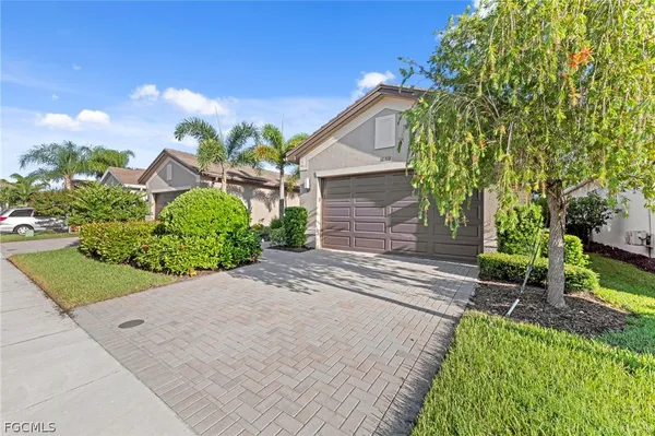 a front view of a house with a yard and outdoor seating