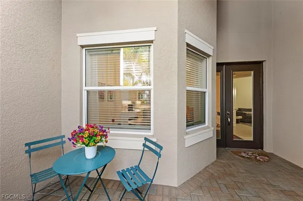 a dining room with furniture and a potted plant