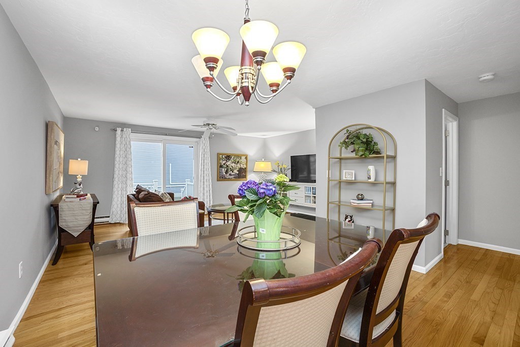 78 Key Street, Unit 78 Millis, MA 02054 - Photo 14 of 33 a view of a dining room with furniture a chandelier and wooden floor