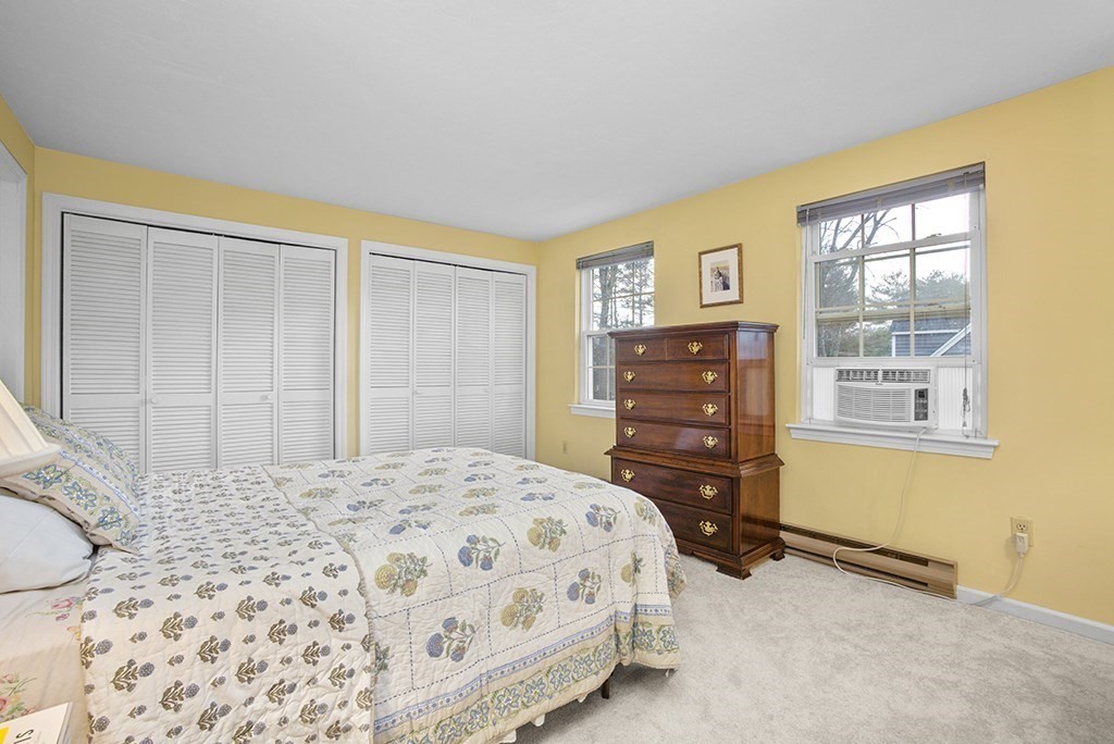 78 Key Street, Unit 78 Millis, MA 02054 - Photo 19 of 33 a bedroom with a bed and wooden floor