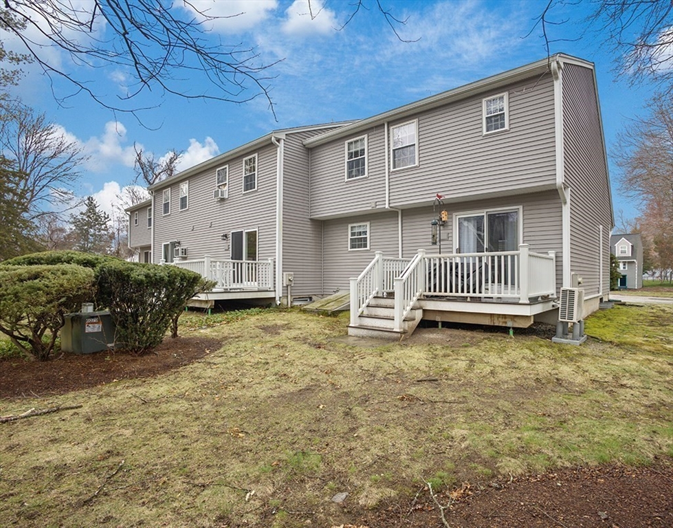78 Key Street, Unit 78 Millis, MA 02054 - Photo 27 of 33 a view of a house with backyard and sitting area