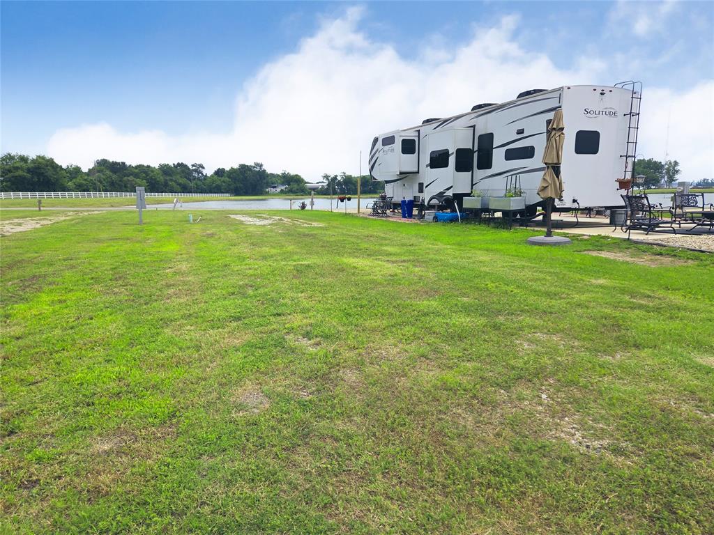 Lot 165 Peninsula Road Kerens, TX 75144 - Photo 15 of 27 a big white house with a big yard and large trees