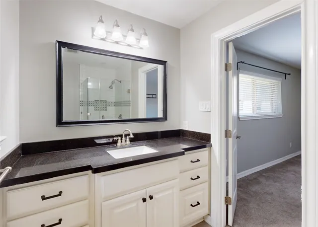 a bathroom with double sink and a mirror