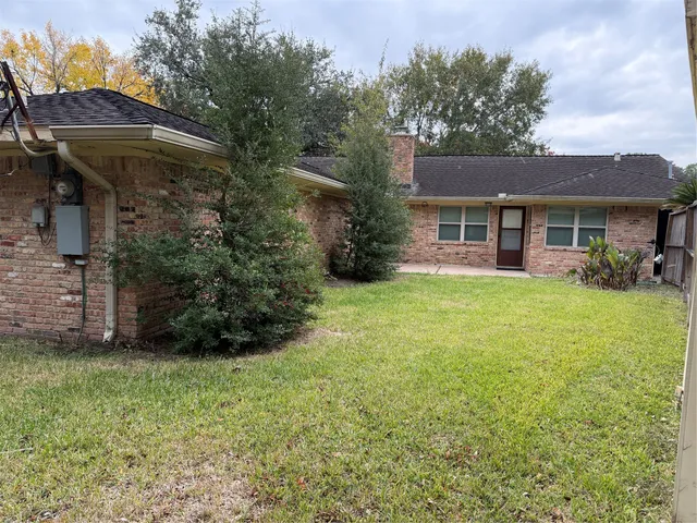 a view of a house with backyard and sitting area