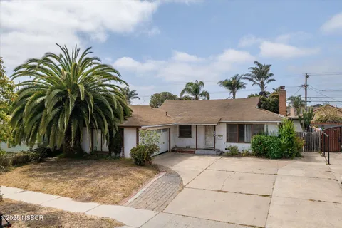 a house with palm tree in front of it