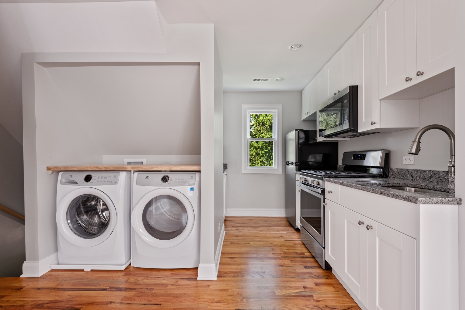 1131 Ridge Road, Unit 2 Wilmette, IL 60091 - Photo 3 of 11 a kitchen with a stove top oven sink and cabinets