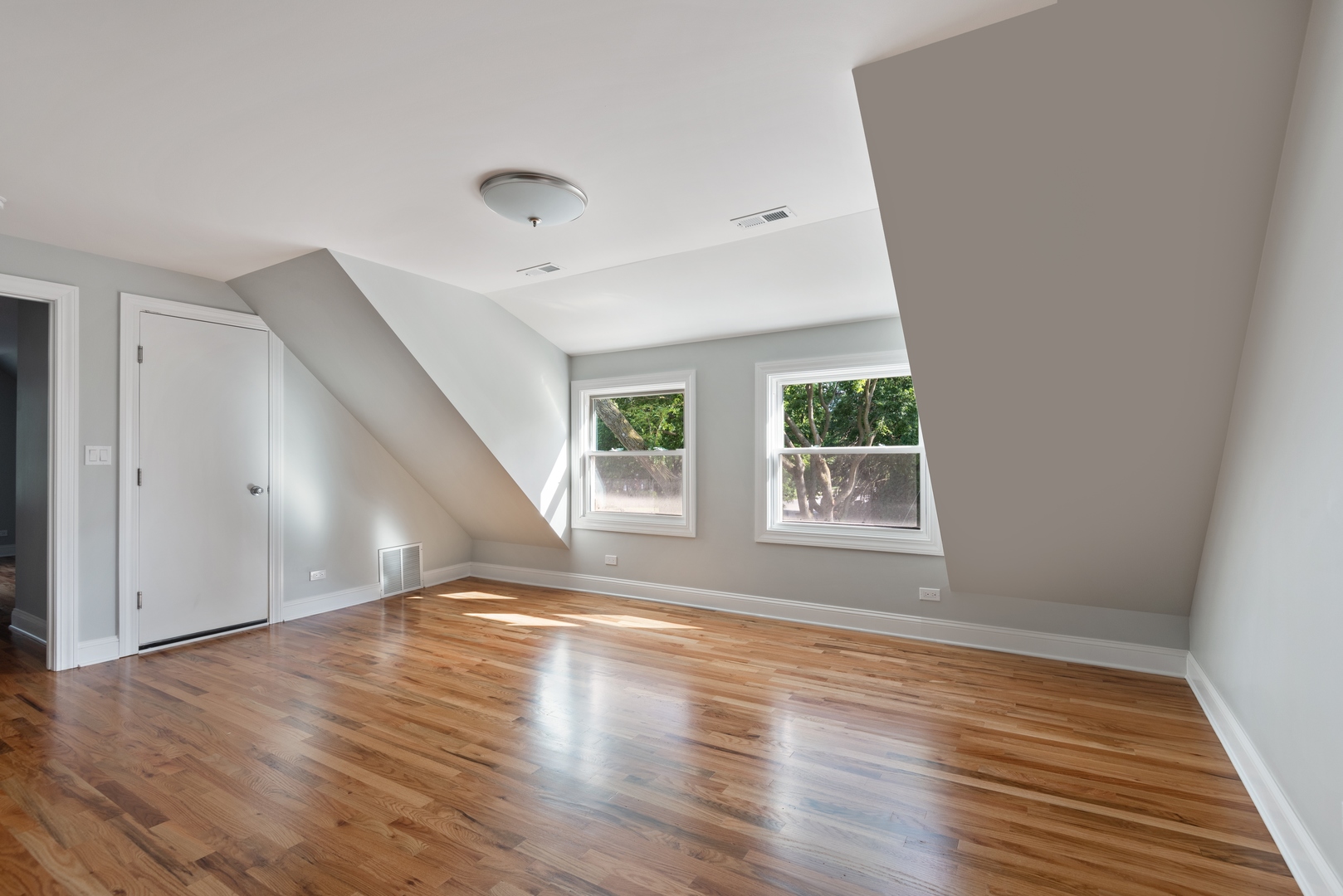 1131 Ridge Road, Unit 2 Wilmette, IL 60091 - Photo 4 of 11 an empty room with wooden floor and windows