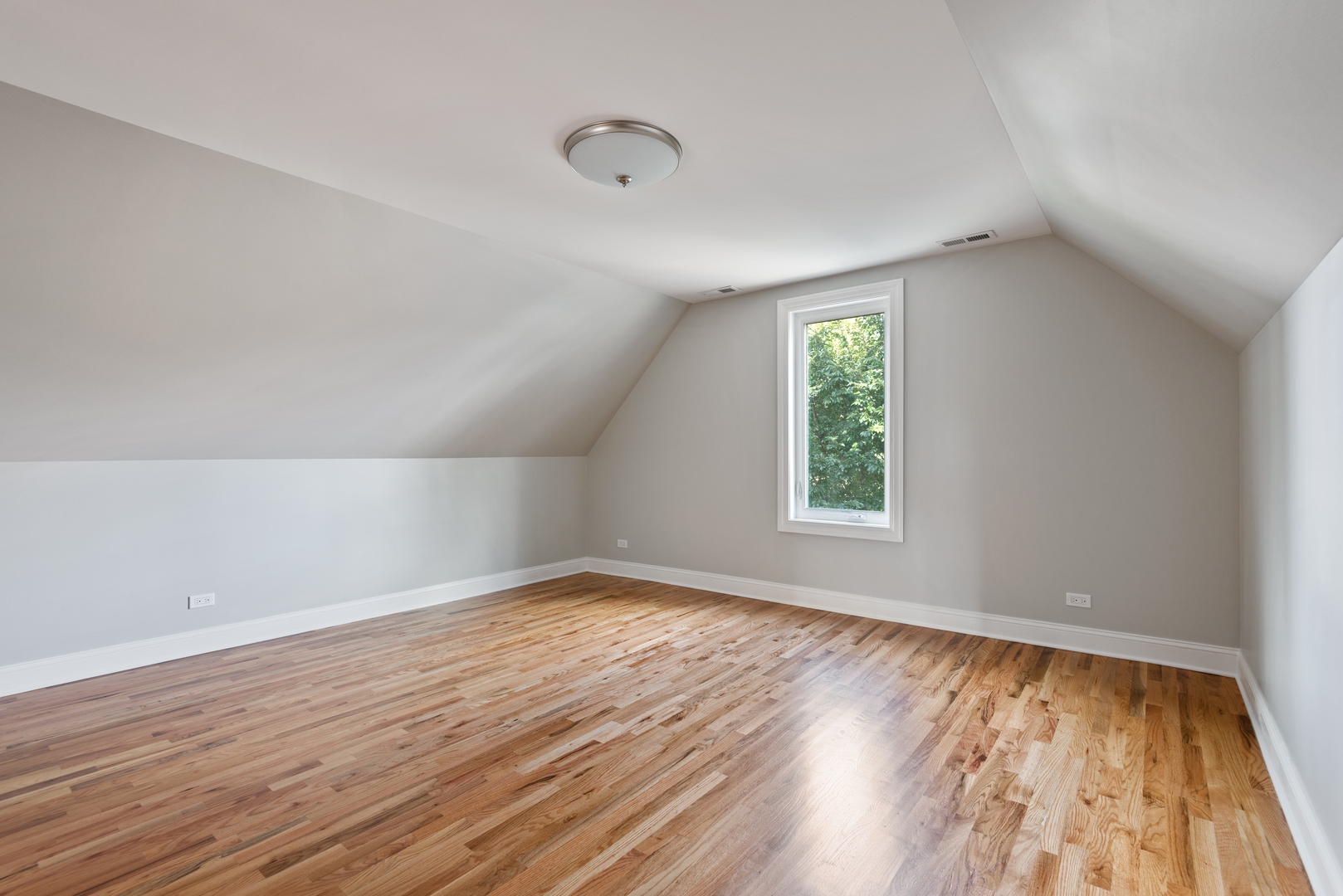 1131 Ridge Road, Unit 2 Wilmette, IL 60091 - Photo 7 of 11 an empty room with wooden floor and windows