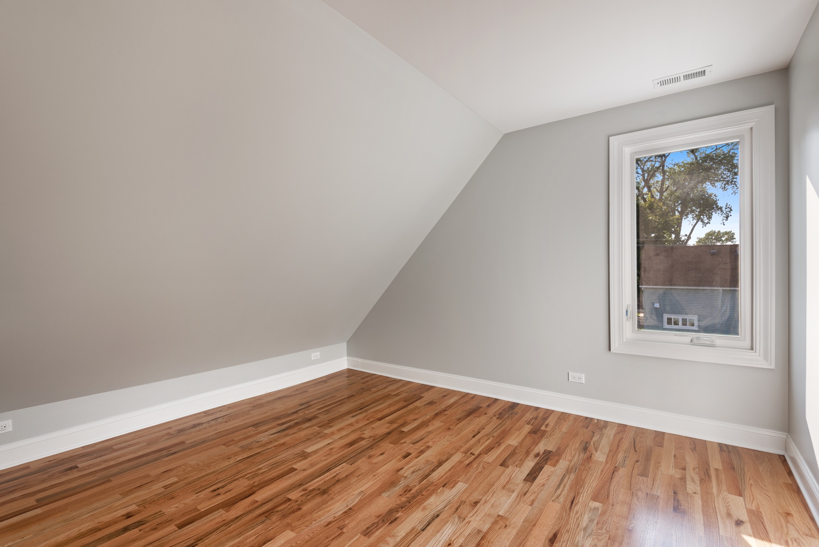 1131 Ridge Road, Unit 2 Wilmette, IL 60091 - Photo 9 of 11 an empty room with wooden floor and a window