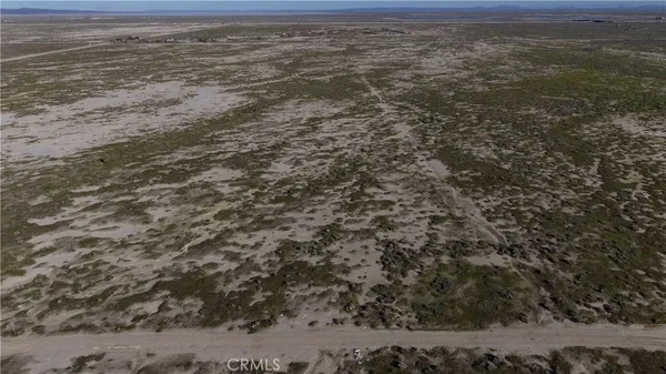 a view of a field with an ocean view