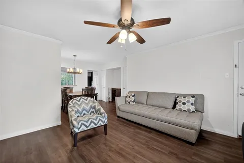 a living room with furniture a bed and a chandelier